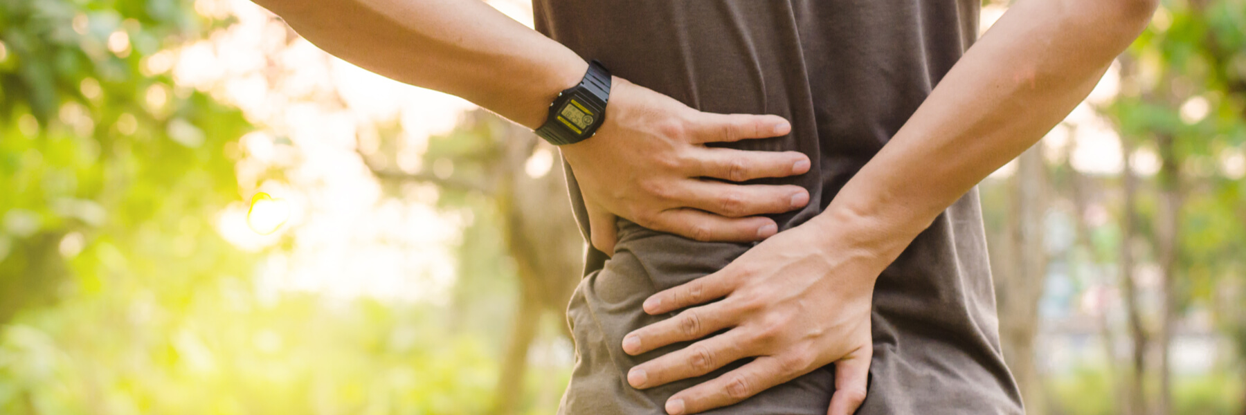 man holding onto his lower back, ache or pain concept